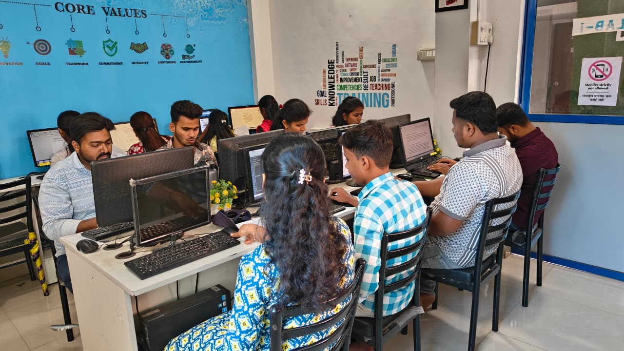 Students working in the lab under the core values wall